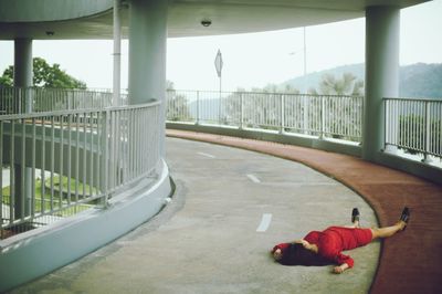 Woman lying on bridge