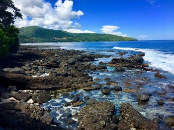 Rocks on beach against sky