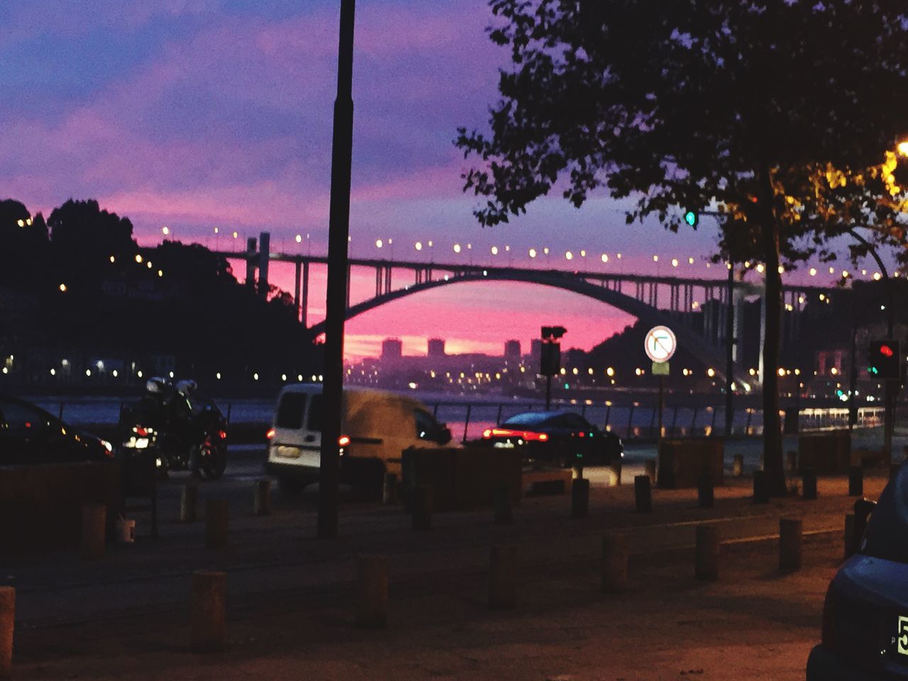 built structure, illuminated, architecture, silhouette, tree, connection, dusk, bridge - man made structure, sky, dark, travel destinations, engineering, building exterior, tourism, city life, suspension bridge, outdoors, famous place, bridge, outline