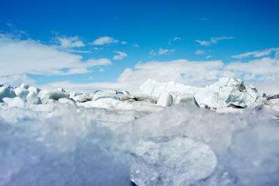 Scenic view of snow covered mountain against blue sky