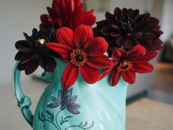 Close-up of red flower vase on table