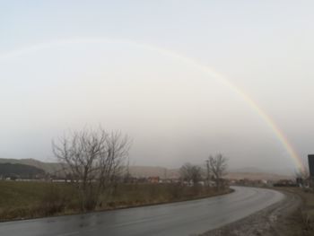 Scenic view of rainbow against sky during winter