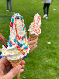 Close-up of hand holding ice cream cone