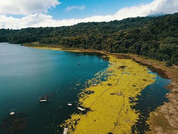 High angle view of lake and trees against sky