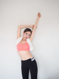 Full length of woman standing against white background