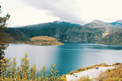 Scenic view of lake and mountains against sky
