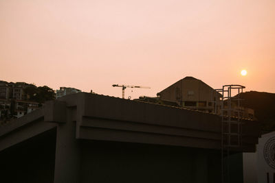 Buildings against sky at sunset