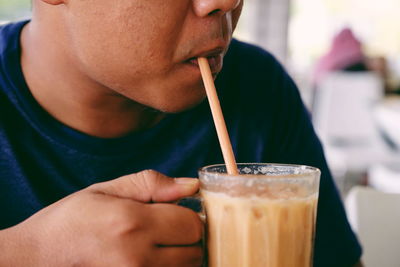Close-up of man drinking drink