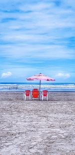 Lifeguard hut on beach against sky