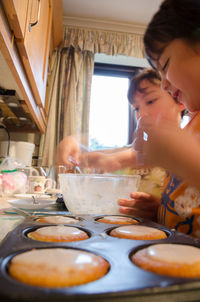 Close-up of girls preparing sweet food at home