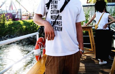 Men standing by boat on shore