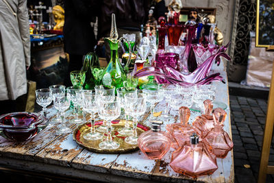 Glasses and bottles on table for sale at market