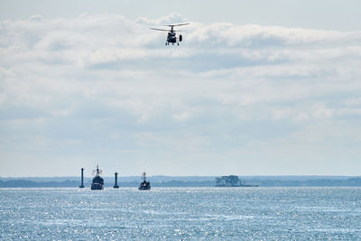 Battleships war ships corvette during naval exercises and helicopter maneuvering over water