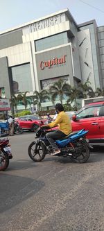 Man riding bicycle on road in city