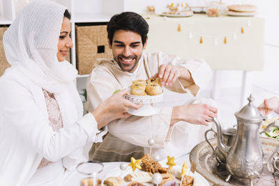 People holding food on table