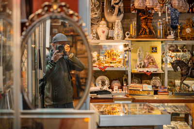 Side view of man standing in store