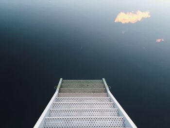 High angle view of ladder leading towards calm lake