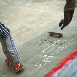 Low section of people skateboarding at park