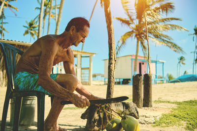 Low section of woman sitting on beach