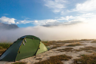 Tent on field against sky