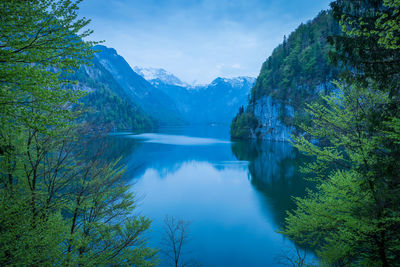 Scenic view of lake and mountains against sky