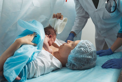 Midsection of doctor examining patient in hospital