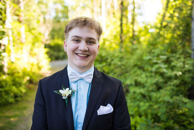 Portrait of happy handsome young man wearing suit.