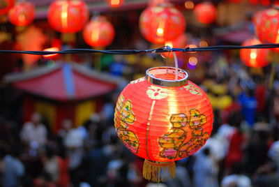 Close-up of illuminated lantern hanging in temple