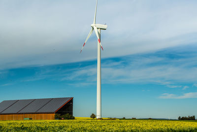 Windmill on field against sky