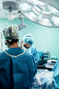 Surgeons standing in operating room