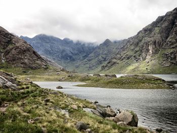 Scenic view of river and mountains against sky