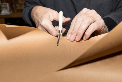 Close-up of hands cutting paper