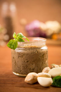 Close-up of garlic paste in jar on wooden table