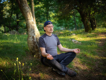 Full length of man sitting on grass