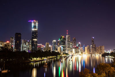 Illuminated buildings against sky at night