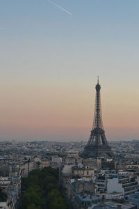 Aerial view of eiffel tower in paris against sky during sunset.