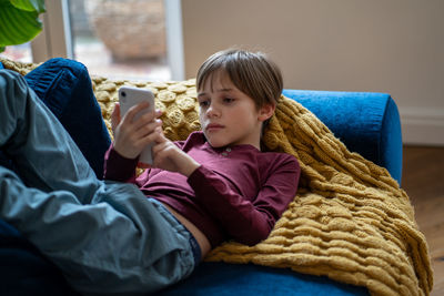 Side view of boy playing with toy