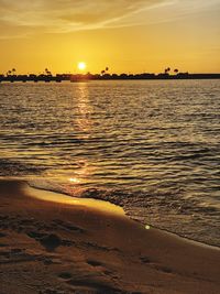 Scenic view of sea against romantic sky at sunset