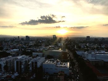 High angle view of buildings against sky during sunset