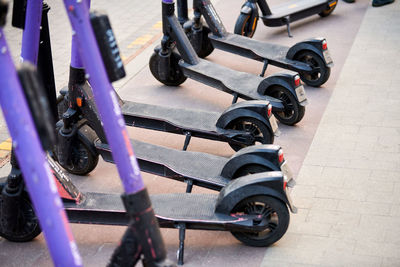 Motorized scooter parking for hourly rent on sidewalk street. ride sharing, electric kick scooters