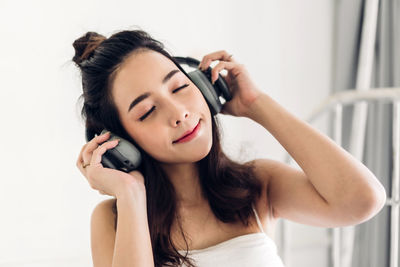 Portrait of young woman using mobile phone