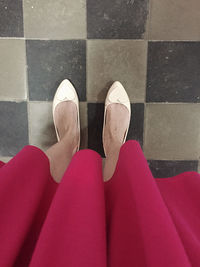 Low section of woman standing on tiled floor