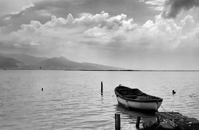 Boat moored on sea against sky