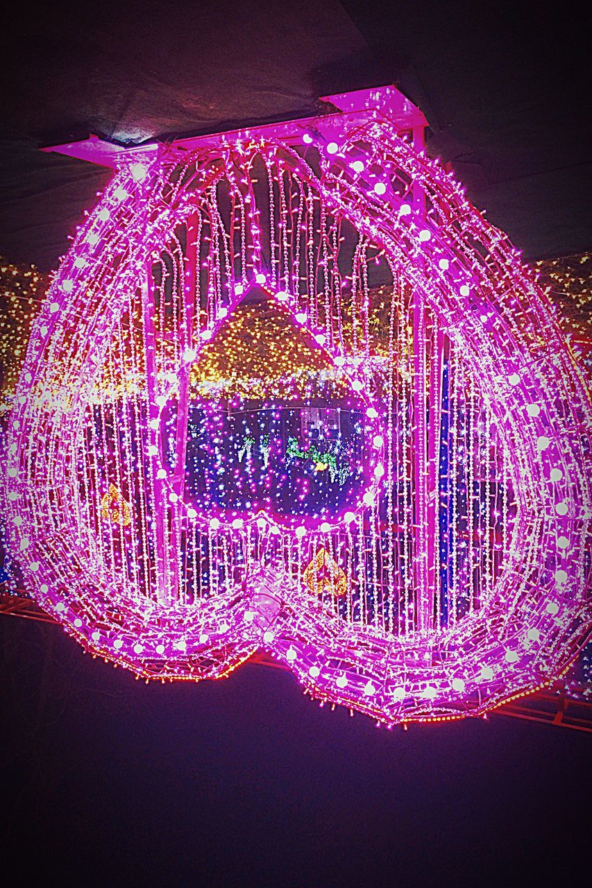 CLOSE-UP OF ILLUMINATED LIGHT AGAINST SKY AT NIGHT