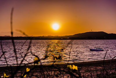 Scenic view of lake against sky during sunset