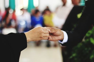 Midsection of couple holding hands