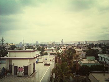 Cityscape against cloudy sky