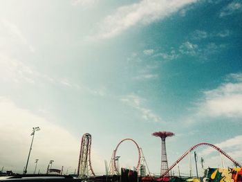 Low angle view of ferris wheel against sky