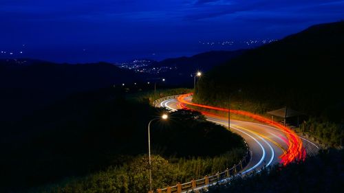 High angle view of light trails on road against sky at night