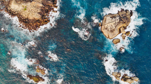 High angle view of rock formation in sea